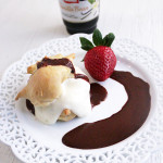Profiterole with berries and chocolate sauce